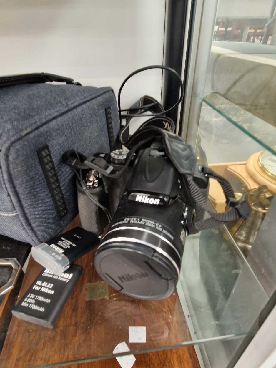 A cased Nikon Coolpix P 600 camera, two batteries, charging lead, etc.