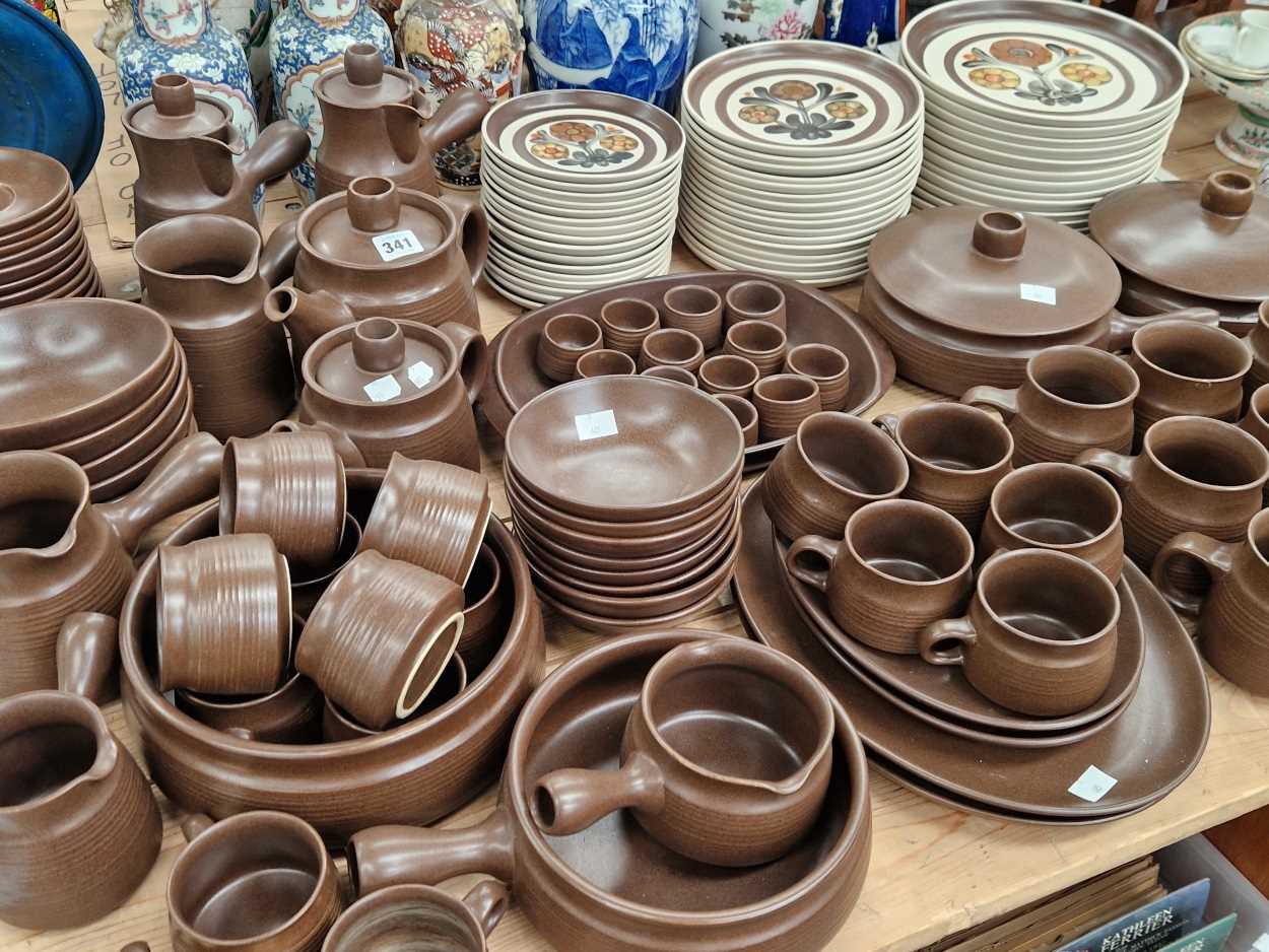 Langley stone ware plates decorated with three flower stems together with a brown glazed stone