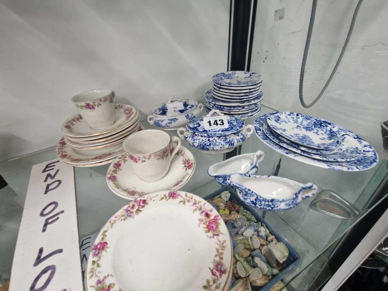 A blue and white pottery childs dinner service together with a part coffee set printed with coloured