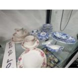 A blue and white pottery childs dinner service together with a part coffee set printed with coloured