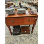 A mahogany side table with deep drawer.