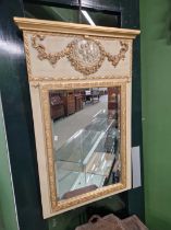 A painted and gilded wall mirror.