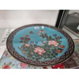 A Japanese cloisonne blue ground dish worked with flowers and a butterfly