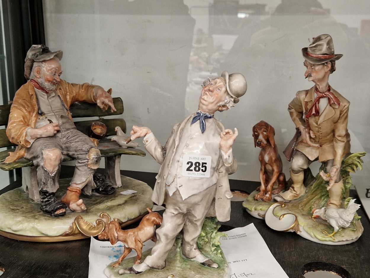 Three Capodimonte figures of characterful men with birds and with dogs