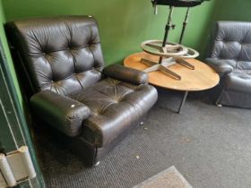 A pair of retro leather upholstered arm chairs.