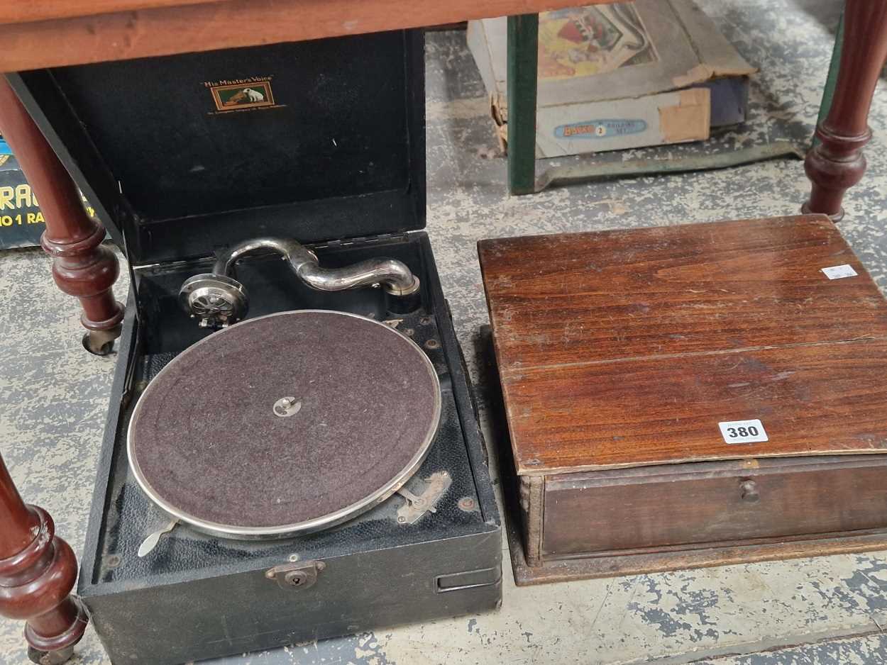 An HMV black cased wind up gramophone together with records in a wooden case