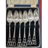 A set of six hallmarked silver grapefruit spoons in the Art Deco taste.
