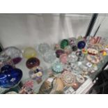 A collection of mainly glass paperweights