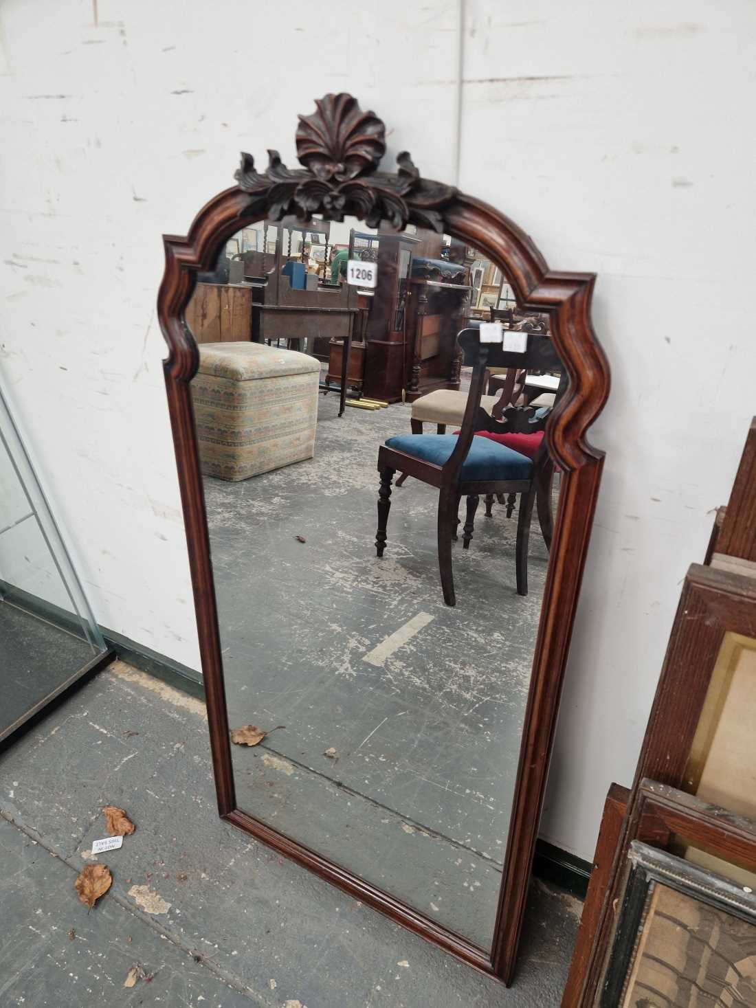 An antique carved walnut framed mirror.