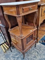 A pair of antique walnut marble top bedside cabinets.