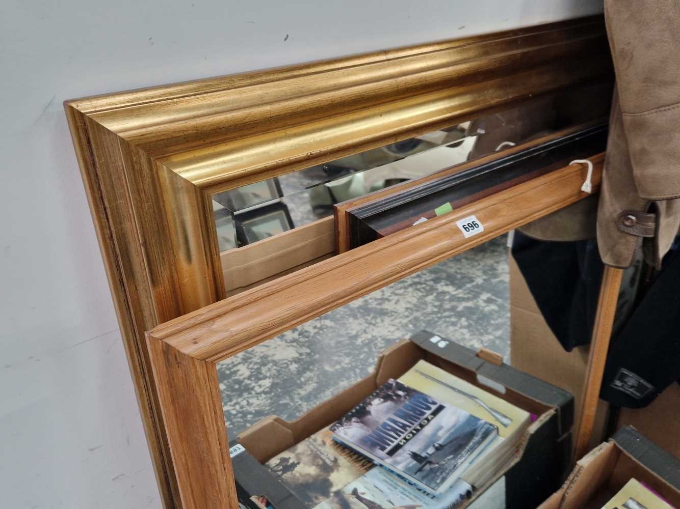 A large gilt framed wall mirror and two others.