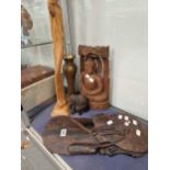 A carved wood Buddha, a pair of African  head and shoulder wall plaques, a carved wood standing