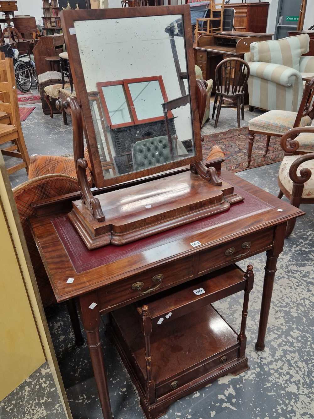 A late Victorian mahogany small writing table together with a swing mirror.