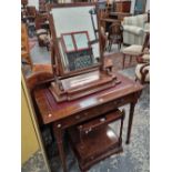 A late Victorian mahogany small writing table together with a swing mirror.