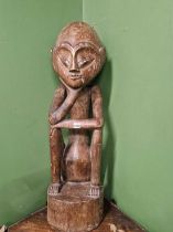 A large carved African figure, approximately 100cm tall. Height is approximately 100 cm tall.