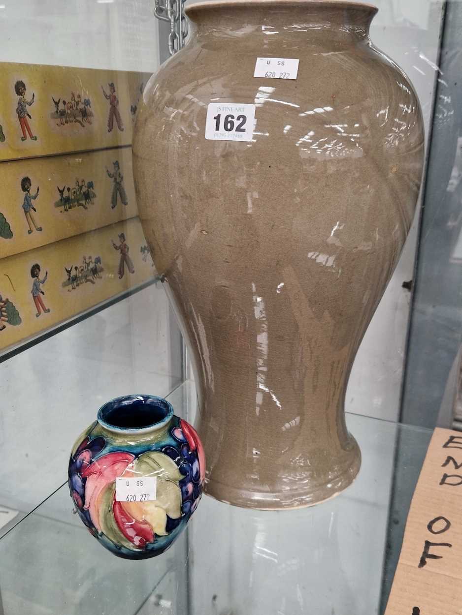 A Moorcroft grey baluster vase H 38cm together with a Moorcroft ovoid vase slip trailed with