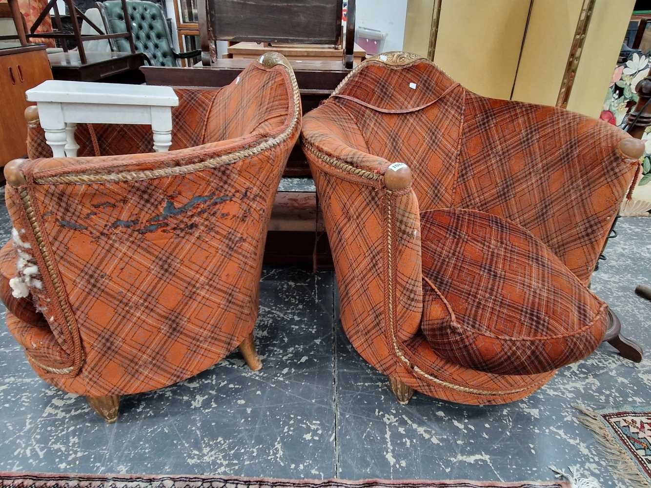 A pair of French gilt show frame club armchairs.