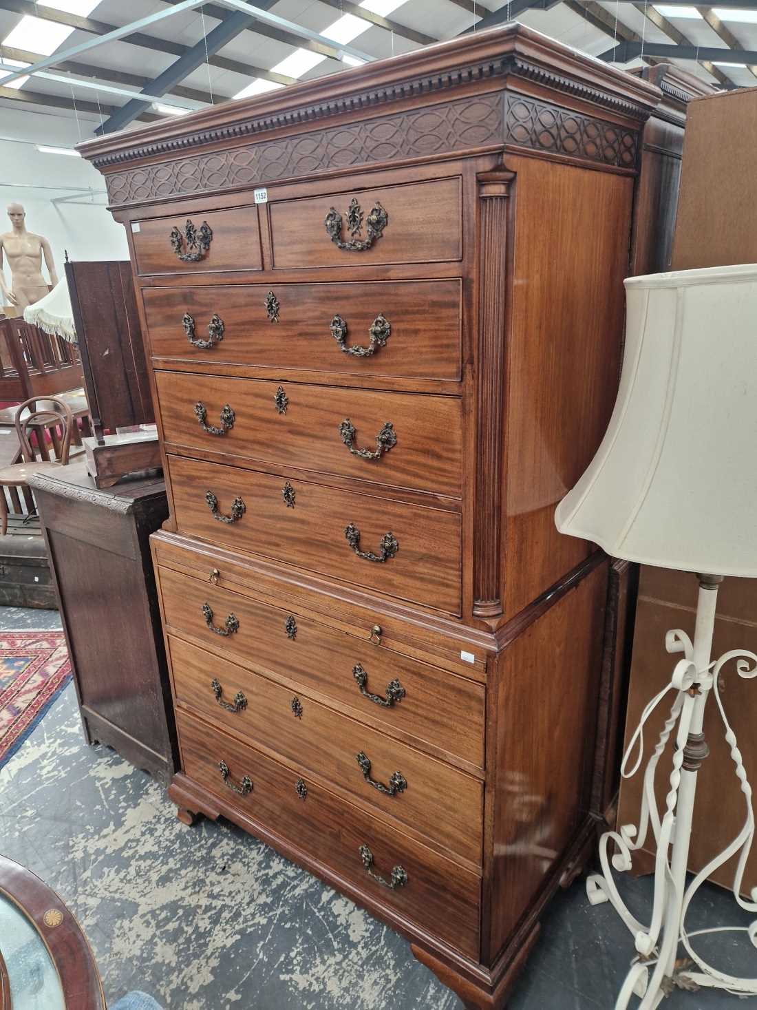 A Georgian mahogany chest on chest with brushing slide.