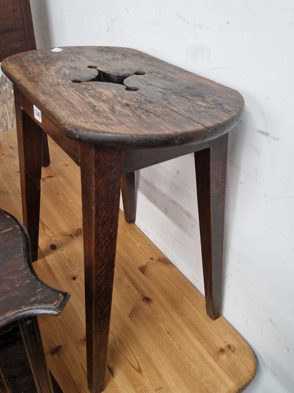 A rustic oak cottage stool.