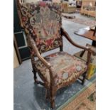 An antique tapestry upholstered 17th style armchair.