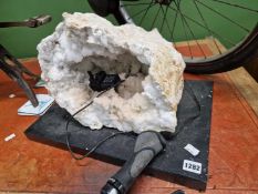 A large geode in two parts mounted on two plinths.