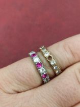 An 18ct hallmarked white gold and an unhallmarked 9ct gold stone set full eternity ring. Gross