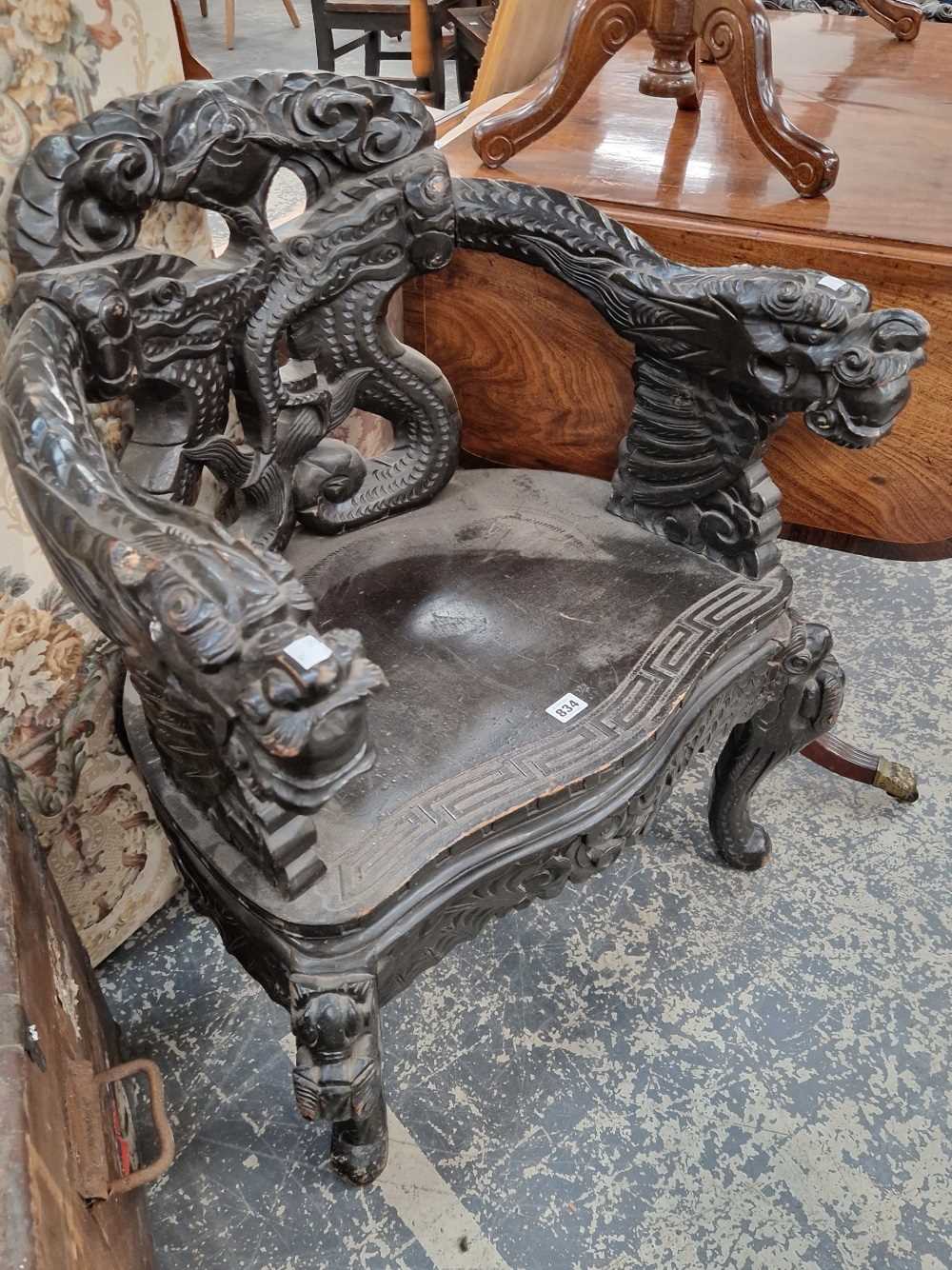 Two similar Oriental carved throne armchairs.