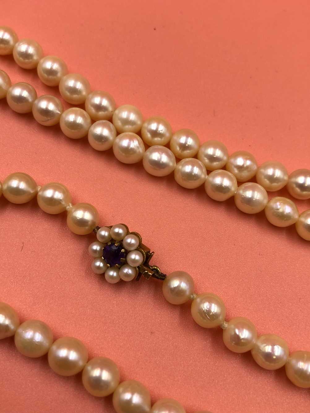 A opera length row of  slightly graduated cultured pearls complete with a 9ct gold stamped - Image 4 of 5