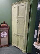 A Georgian oak floor standing painted corner cabinet.