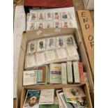 An album and sheets of cigarette cards
