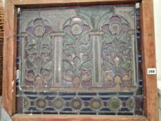 A pine framed leaded glass panel of three arches of flowers between columns