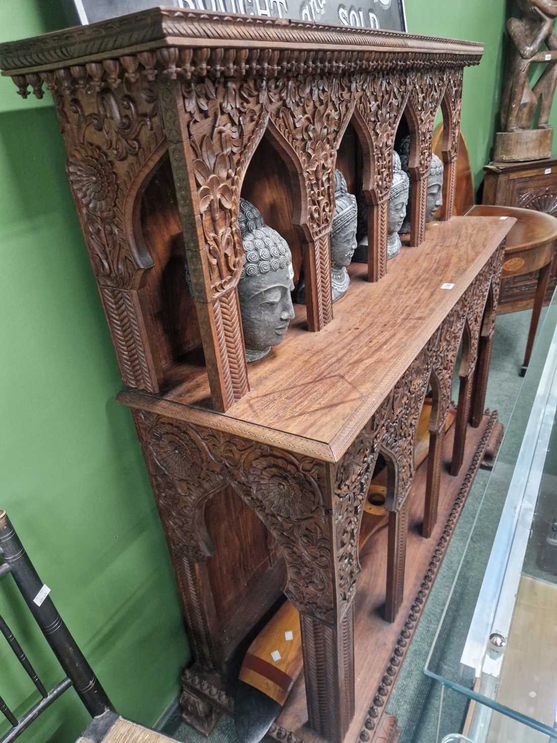 A carved hardwood alter form hall table.