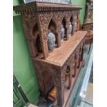 A carved hardwood alter form hall table.