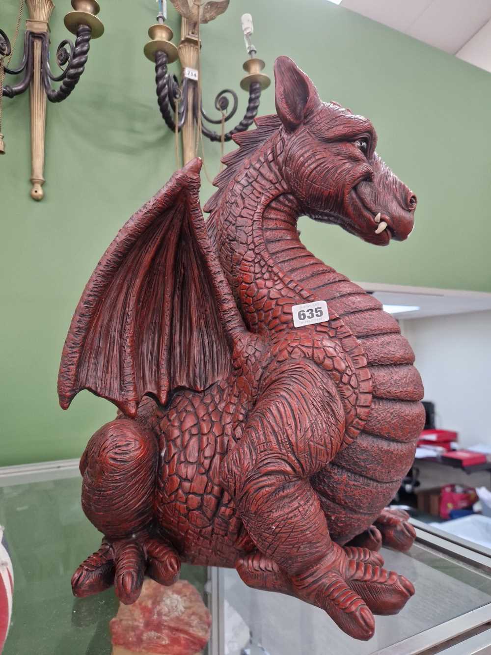 A large red dragon figure. H 51cms W 43cms