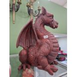 A large red dragon figure. H 51cms W 43cms