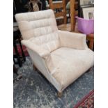 A Victorian deep seat button back armchair.