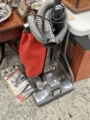 A Kirby Heritage vacuum cleaner with some spare bags