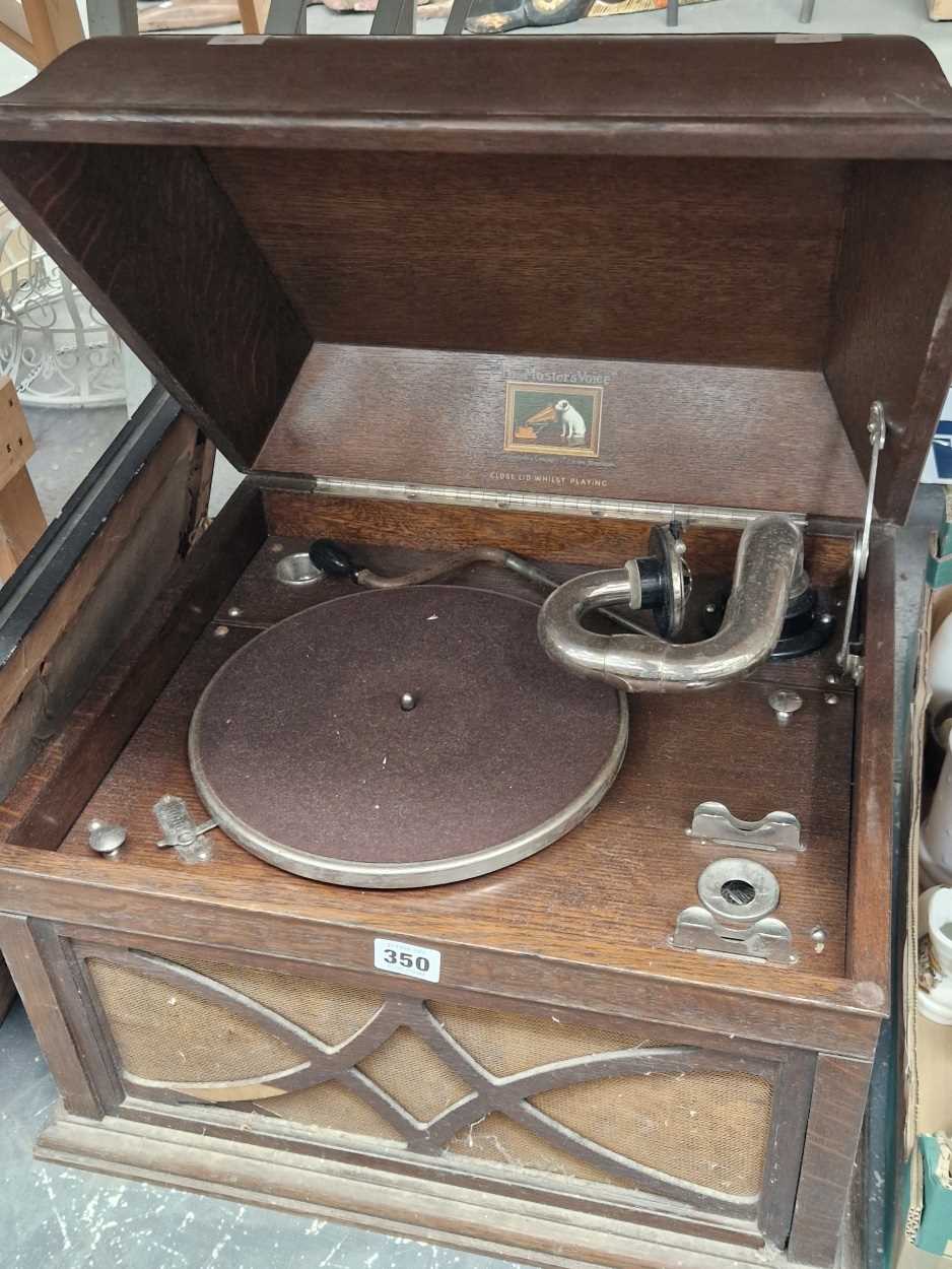 An HMV oak cased wind up gramophones together with a print