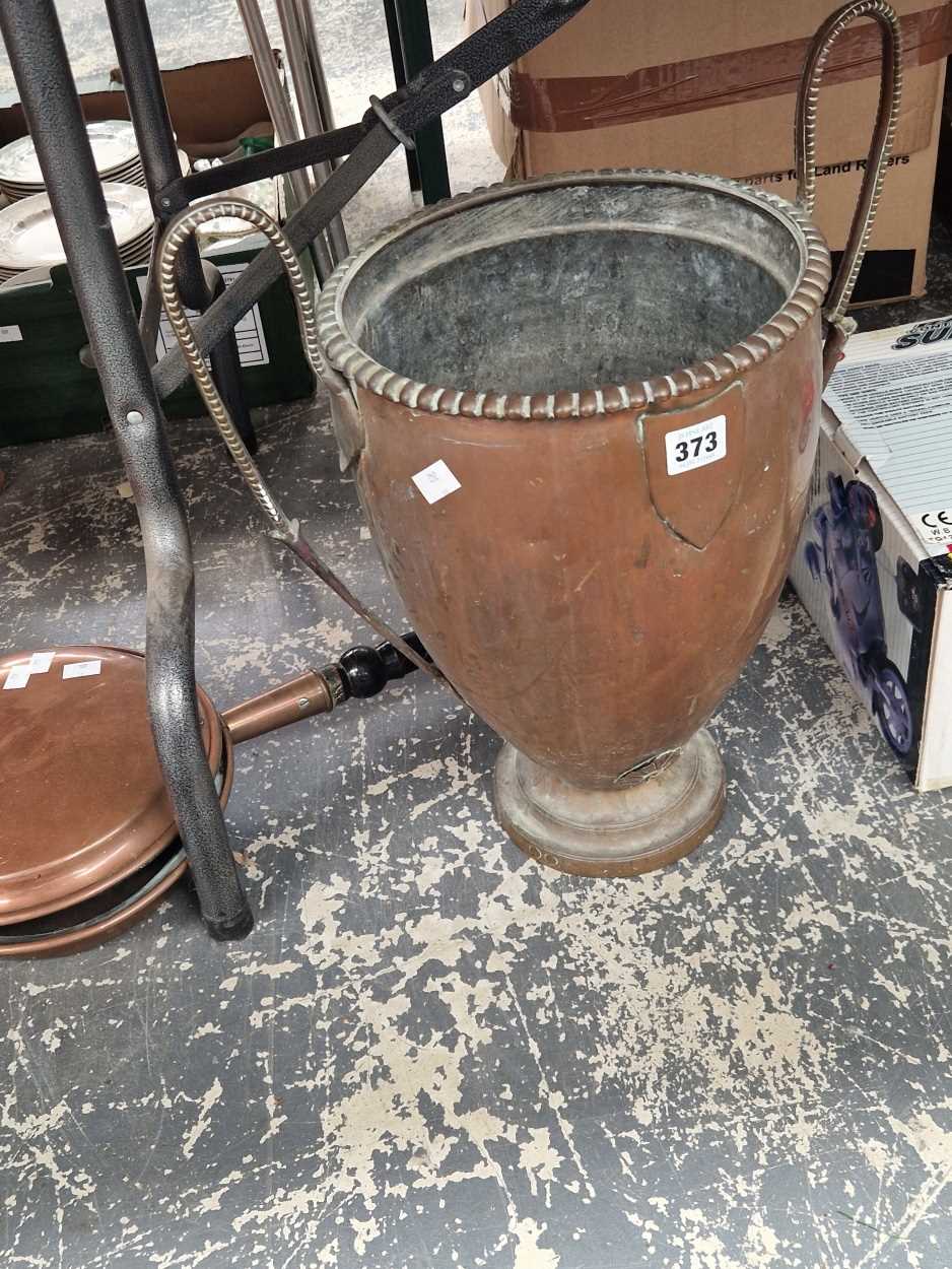 A copper two handled vase together with a copper warming pan