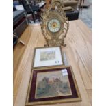 An antique cast brass cased easel back mantle clock together with two small watercolour and a