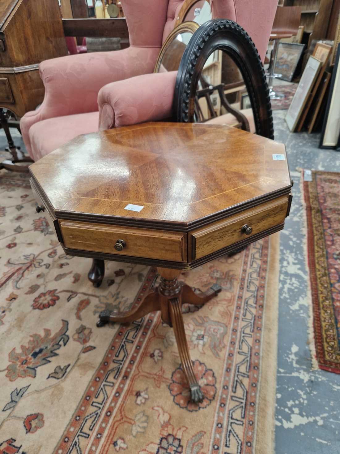 A mahogany small drum table and an oval mirror.