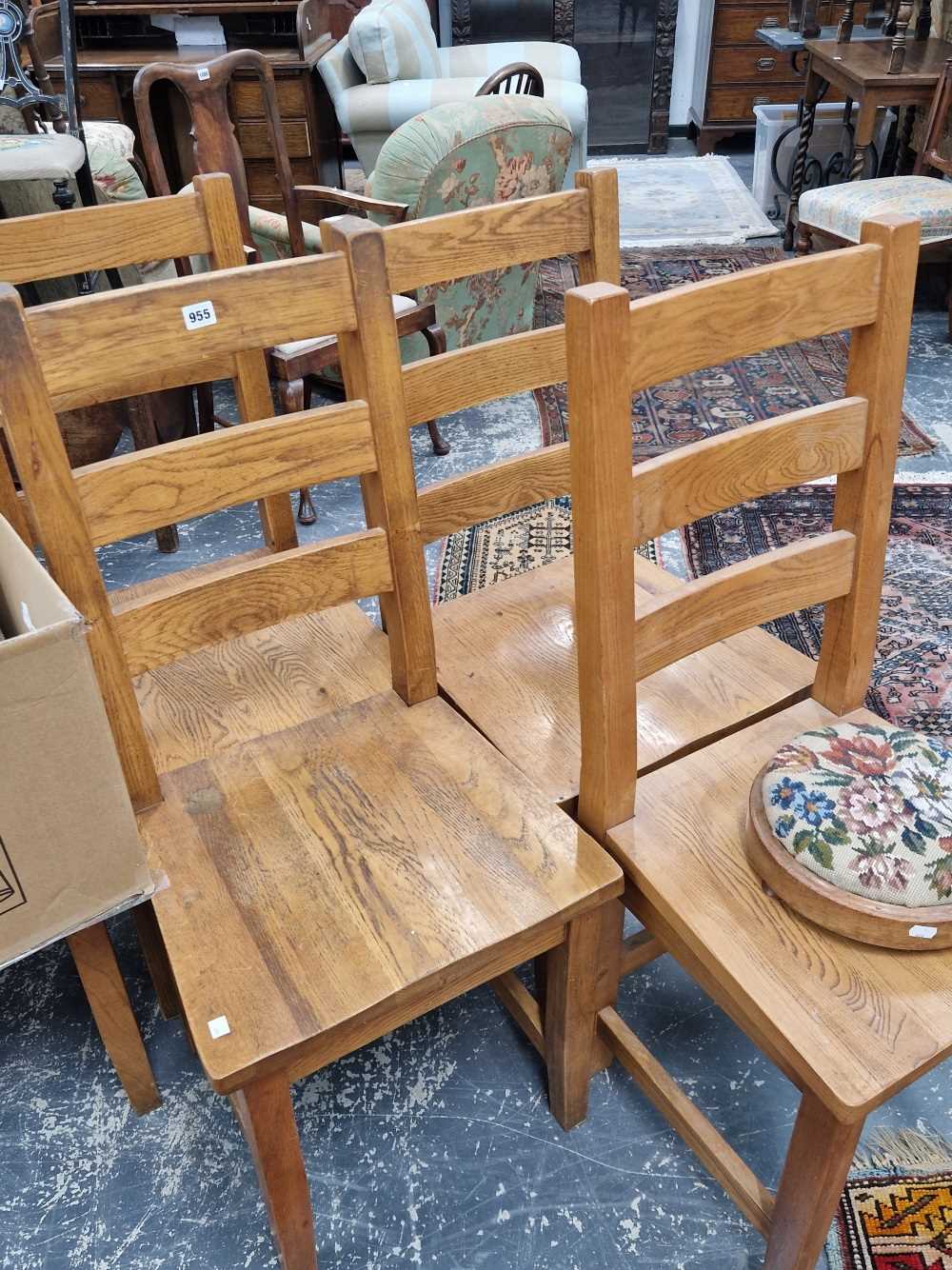 A set of 8 heavy oak dining chairs.
