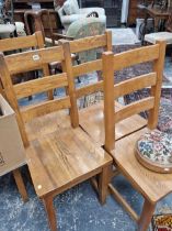 A set of 8 heavy oak dining chairs.