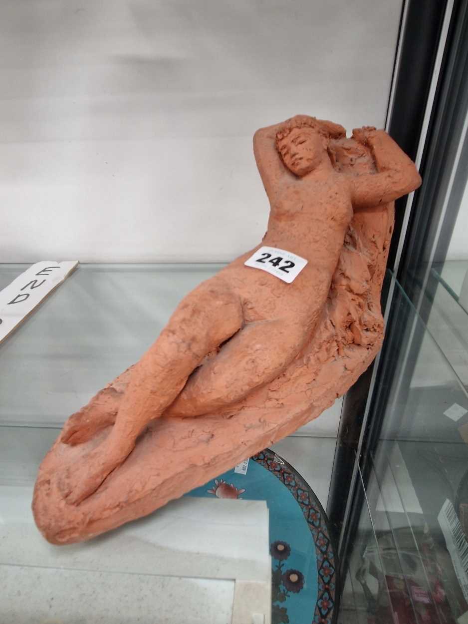 A Karin Jonzen terracotta sculpture of a reclining nude