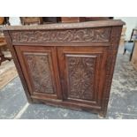 A carved oak side cabinet.