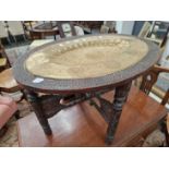 A brass topped hardwood Benares table.