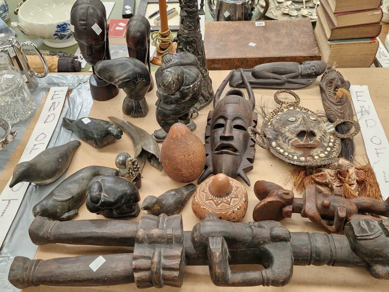 Inuit carved stone figures together with African wood masks, figures, horn and bronze
