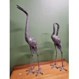 A pair of crane figures.