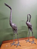 A pair of crane figures.