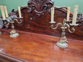 A pair of brass three branch table lights.